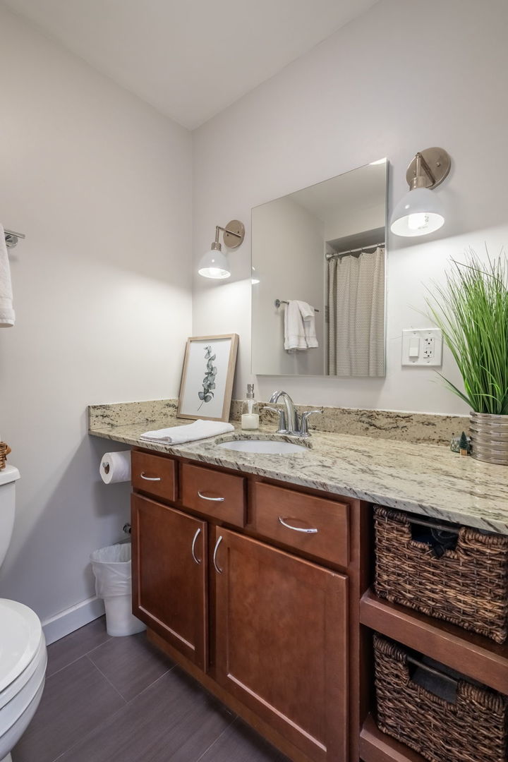 3033 North Sheridan Road, Unit 1203 Chicago, IL 60657 - Photo 14 of 22 a bathroom with a granite countertop sink and a toilet