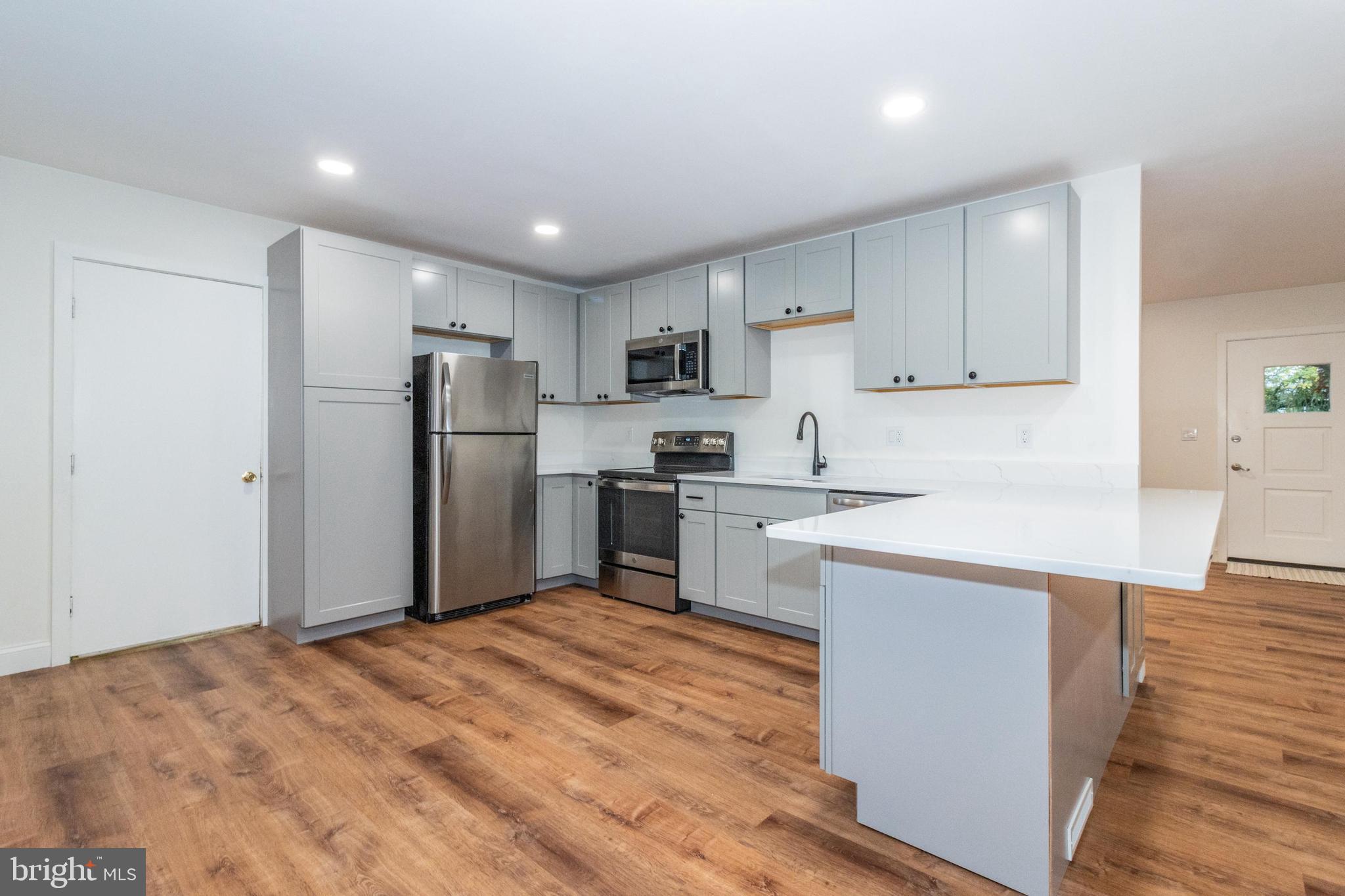 320 Kenmore Avenue Edgewater, MD 21037 - Photo 16 of 43 a kitchen with granite countertop a refrigerator and a sink