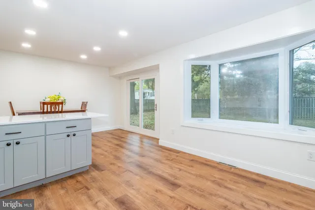 a hall with cabinets and a wooden floor