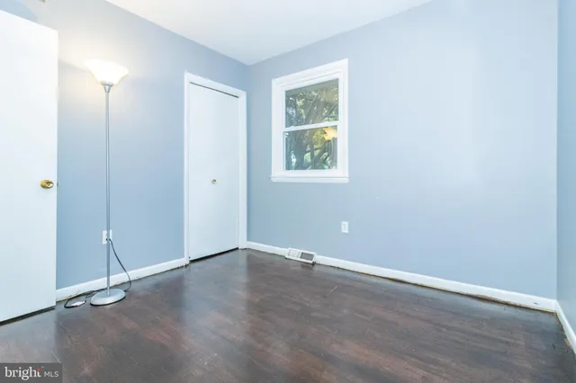 an empty room with wooden floor