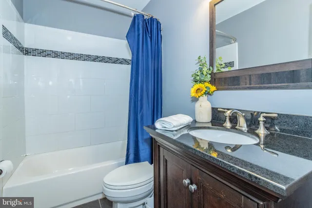a bathroom with a sink vanity and mirror