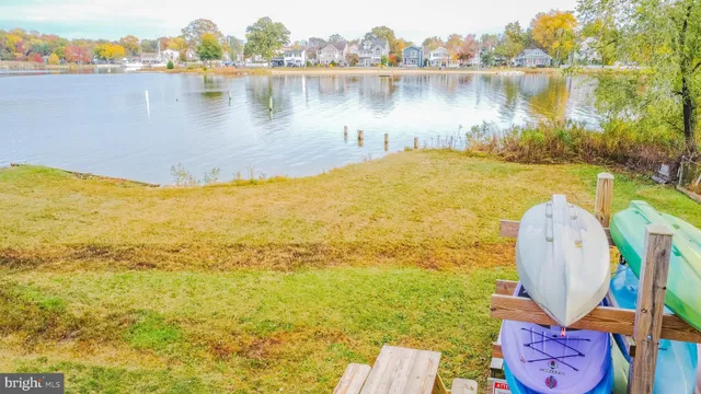 a view of a lake with lawn chairs