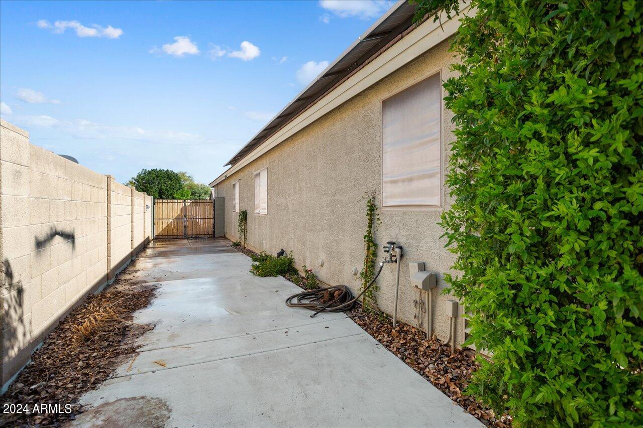 13379 West Boca Raton Road Surprise, AZ 85379 - Photo 33 of 37 a view of a pathway of a house with a yard