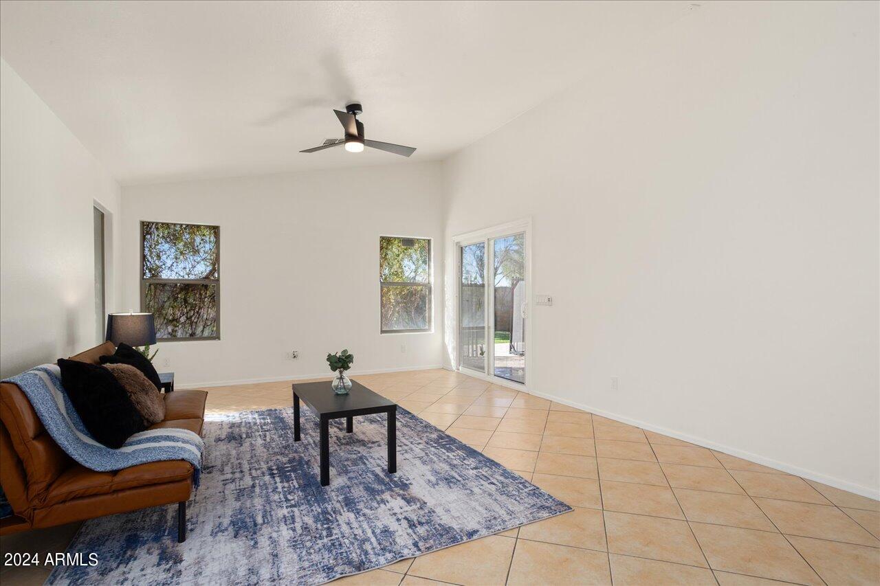 13379 West Boca Raton Road Surprise, AZ 85379 - Photo 10 of 37 a living room with furniture and a rug