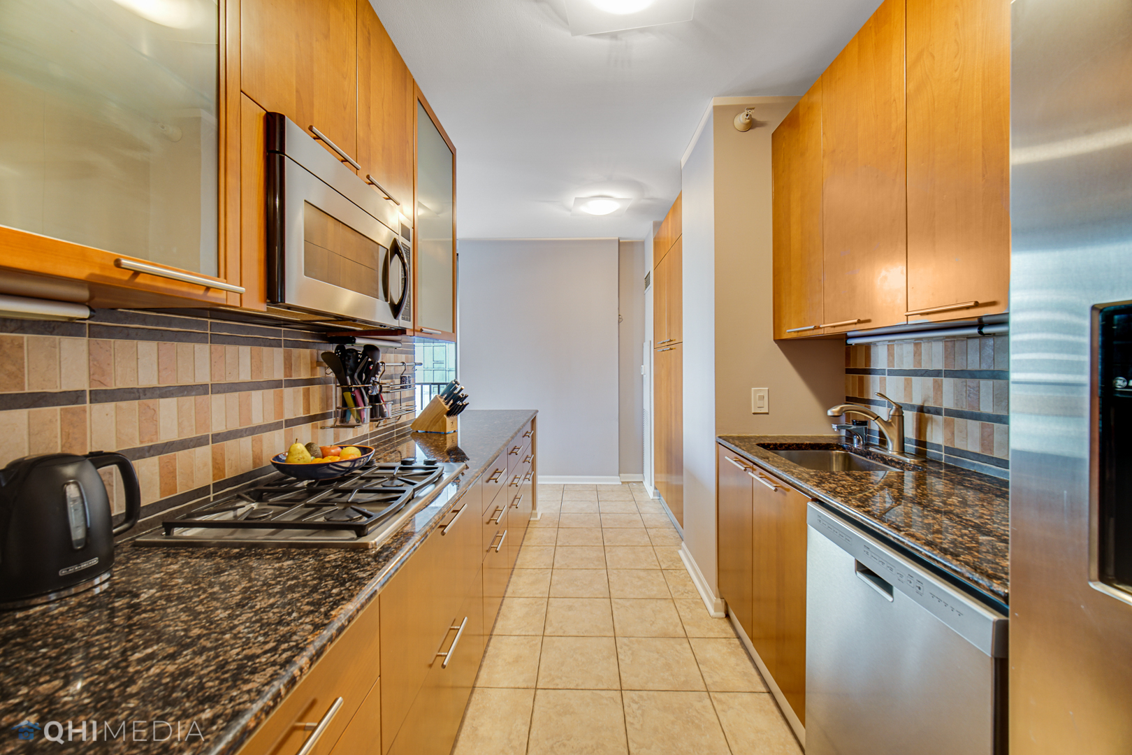 635 North Dearborn Street, Unit 1105 Chicago, IL 60654 - Photo 11 of 27 a kitchen with stainless steel appliances granite countertop a stove and a sink