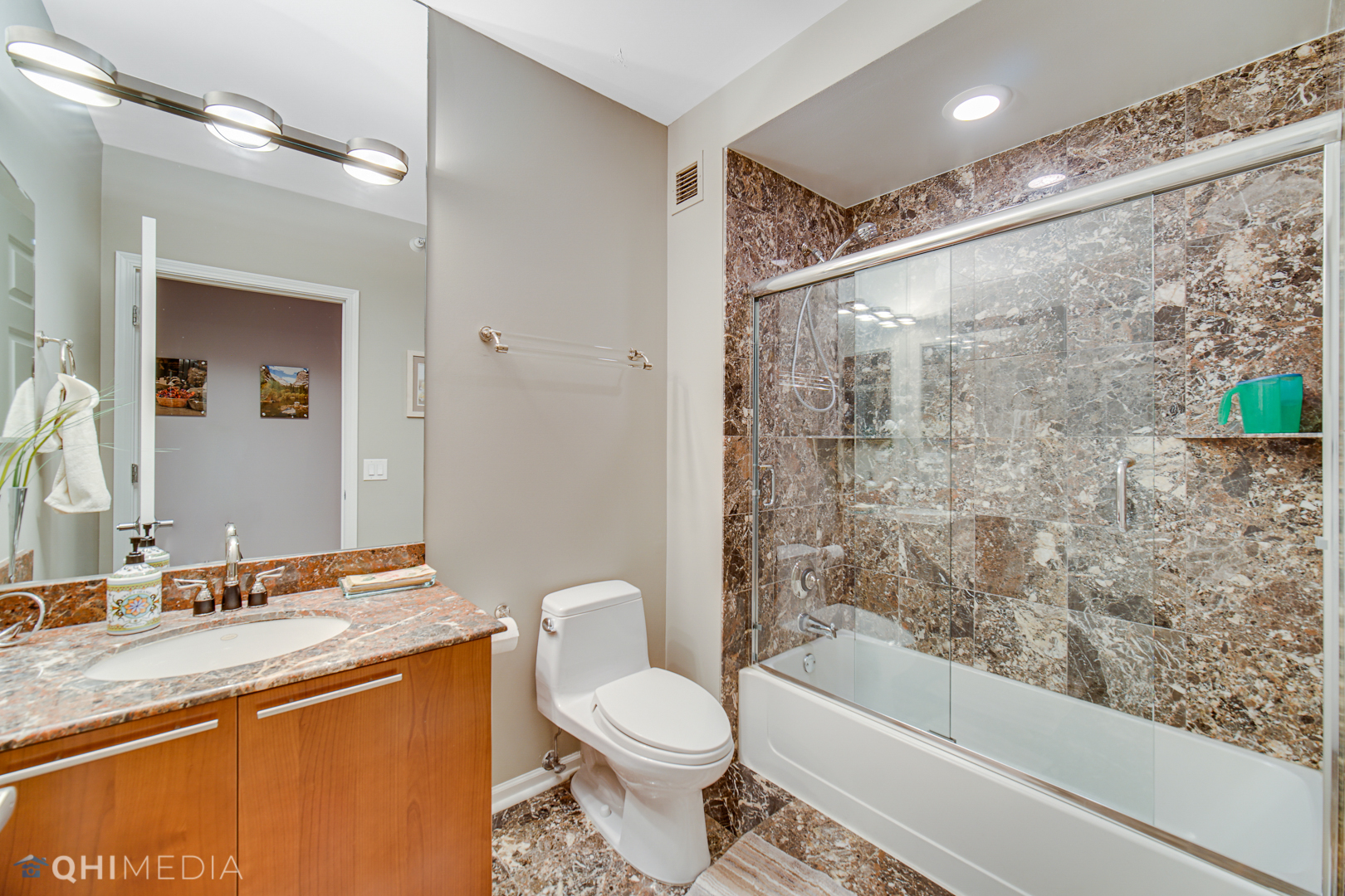 635 North Dearborn Street, Unit 1105 Chicago, IL 60654 - Photo 19 of 27 a bathroom with a granite countertop sink toilet and shower