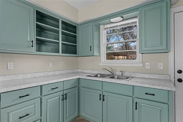 a view with cabinets a window and a sink