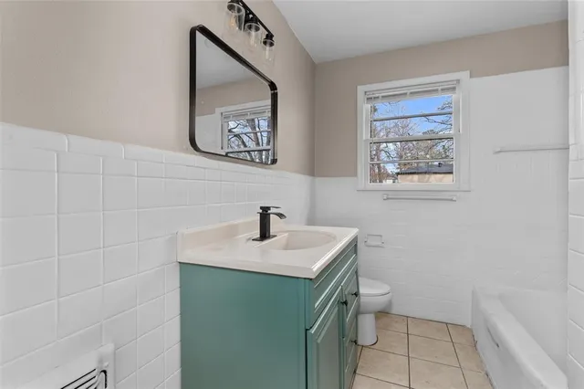a bathroom with a sink toilet and vanity