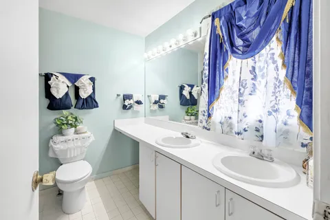 a bathroom with a toilet sink and mirror