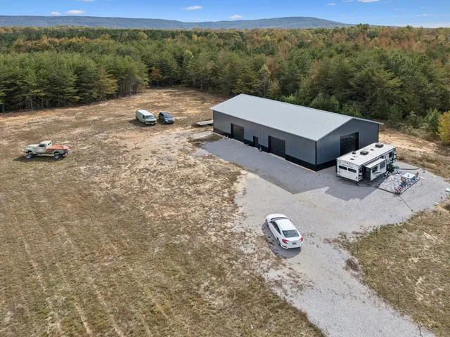 a view of a backyard with table and chairs