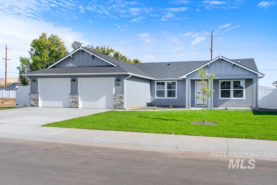 1340 Dawn Street Weiser, ID 83672 - Photo 31 of 32 Single story home with board and batten siding, a garage, concrete driveway, and a shingled roof