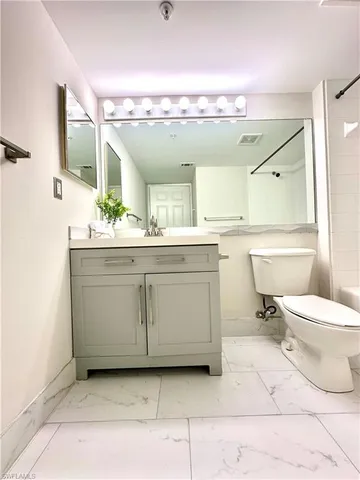 a view of empty room with wooden floor and fireplace