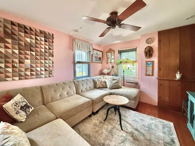 a view of a a dining room with furniture window and wooden floor