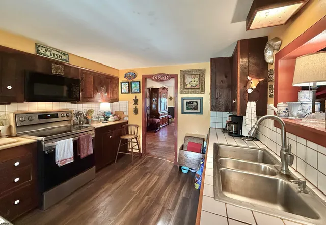 a view of a yard with furniture and garden