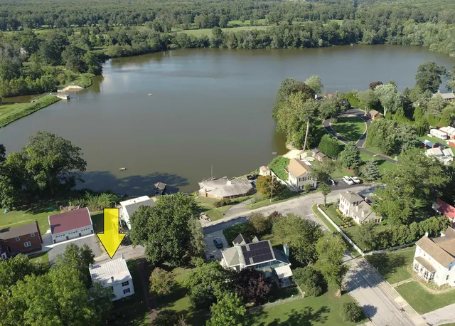 an aerial view of house with yard swimming pool and outdoor seating