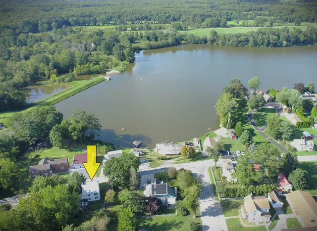 an aerial view of lake residential house with outdoor space and seating