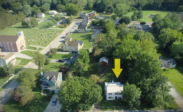 an aerial view of a house with outdoor space pool patio and lake view