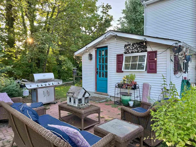 a view of a patio with couches table and chairs and potted plants