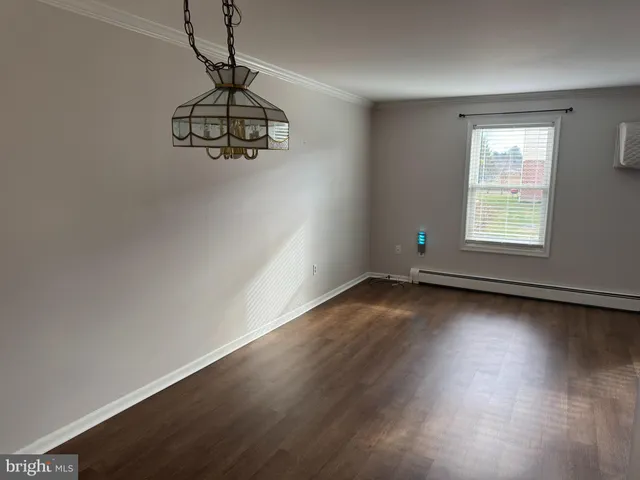 a view of a room with wooden floor and window