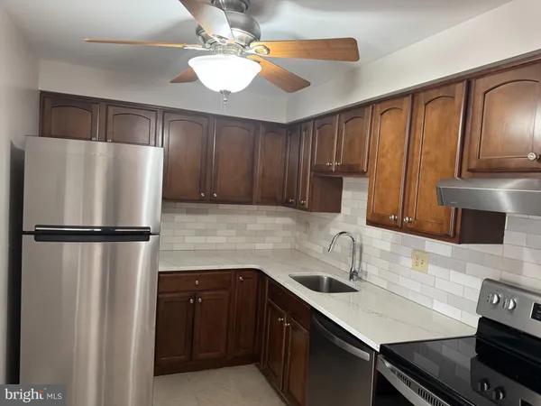 a kitchen with a refrigerator a sink and cabinets