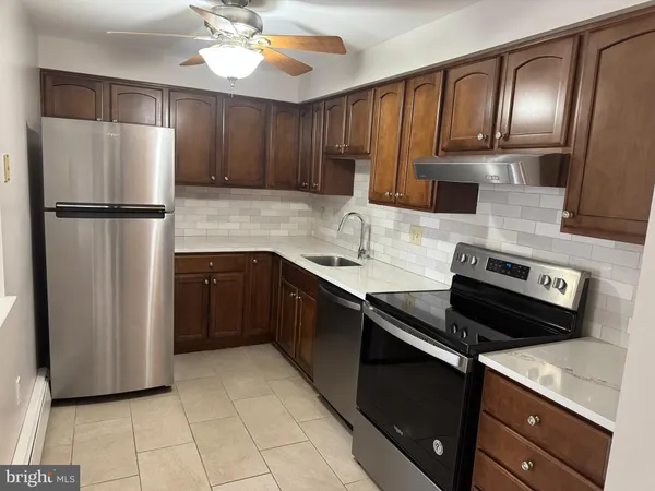 a kitchen with a refrigerator sink and cabinets