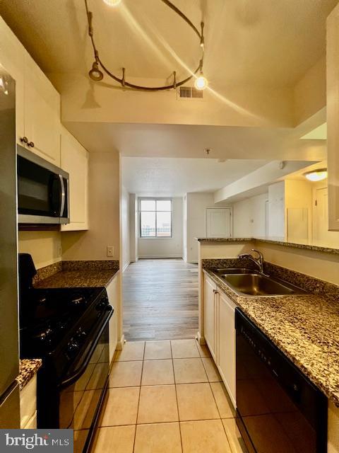 851 North Glebe Road, Unit 1113 Arlington, VA 22203 - Photo 12 of 30 a kitchen with stainless steel appliances granite countertop a stove and a sink