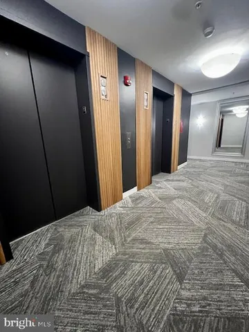 a bedroom with a bed and a mirror