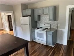 a kitchen with white cabinets and white appliances