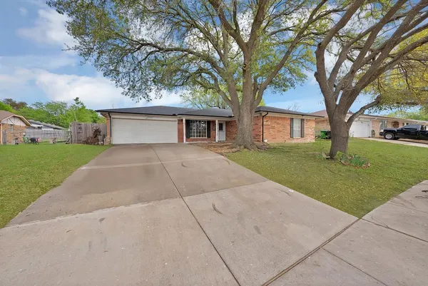 a front view of house with yard and trees