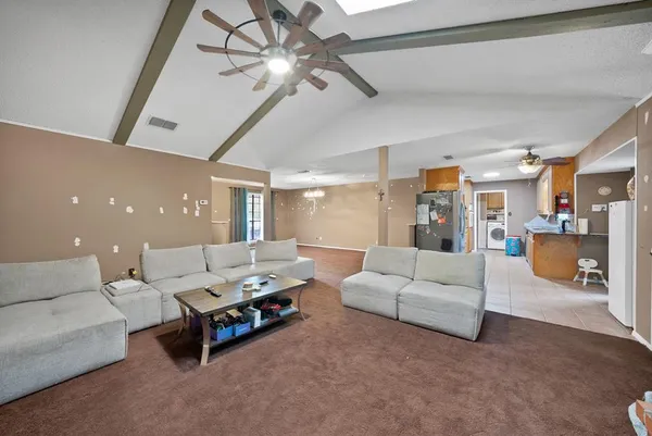 a living room with furniture and a chandelier