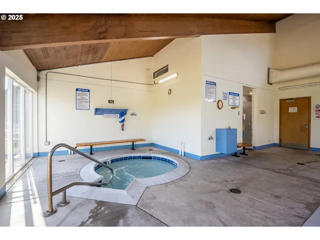 a room with pool table windows and couches