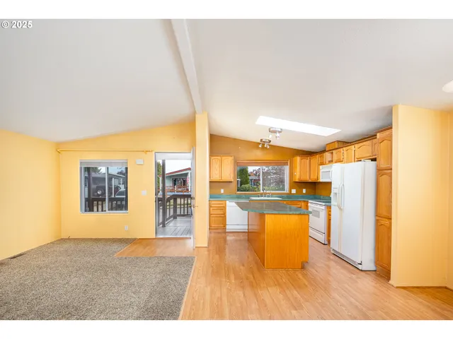 a open kitchen with a refrigerator a stove top oven a sink and dishwasher