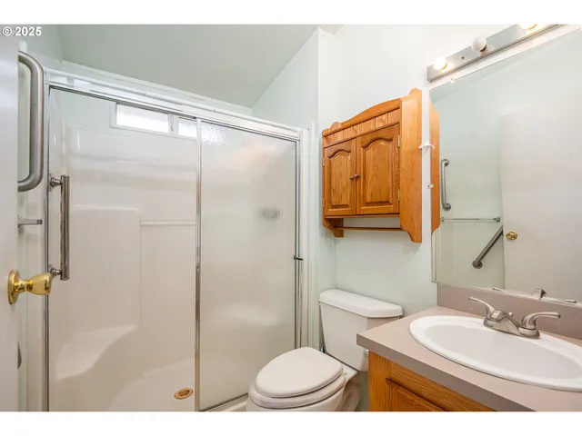 a bathroom with a sink toilet mirror and shower