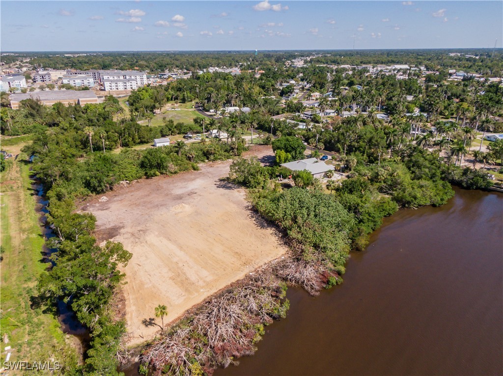 1059 River Road North Fort Myers, FL 33903 - Photo 5 of 15 an aerial view of a house and a yard and mountain view in back