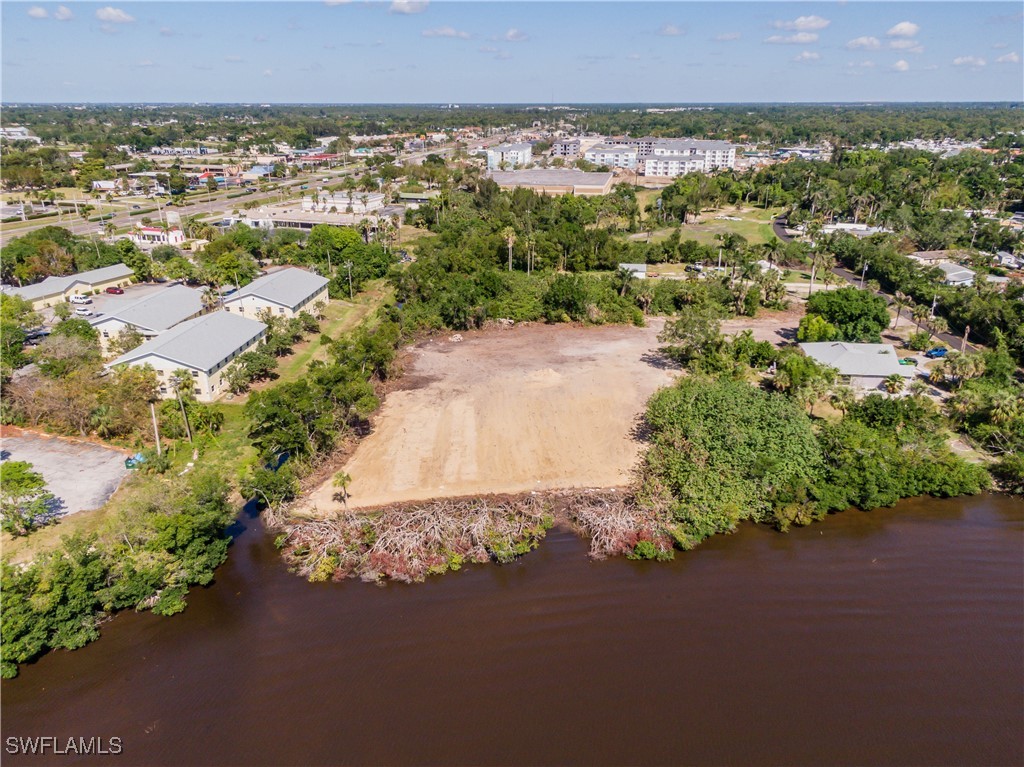 1059 River Road North Fort Myers, FL 33903 - Photo 6 of 15 an aerial view of a house with a yard and lake view in back