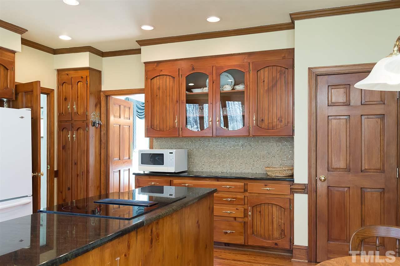 4820 Oak Way Raleigh, NC 27613 - Photo 11 of 25 a kitchen with stainless steel appliances granite countertop a refrigerator and a sink