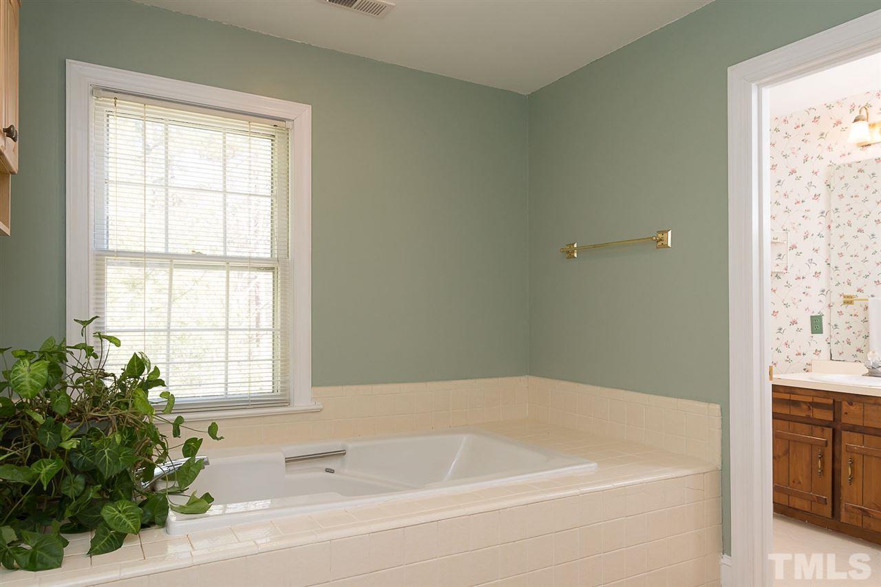 4820 Oak Way Raleigh, NC 27613 - Photo 17 of 25 a white bath tub sitting next to a window