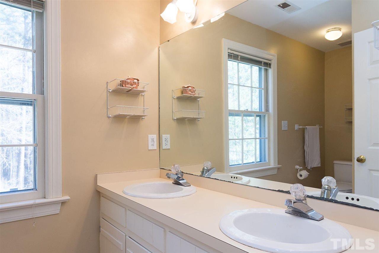 4820 Oak Way Raleigh, NC 27613 - Photo 18 of 25 a bathroom with a sink and a mirror