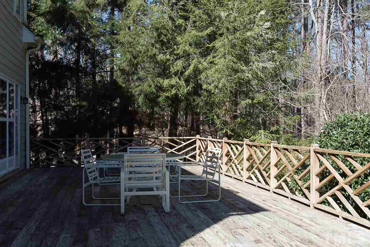 4820 Oak Way Raleigh, NC 27613 - Photo 22 of 25 a view of a chairs and table on wooden deck with wooden floor and fence