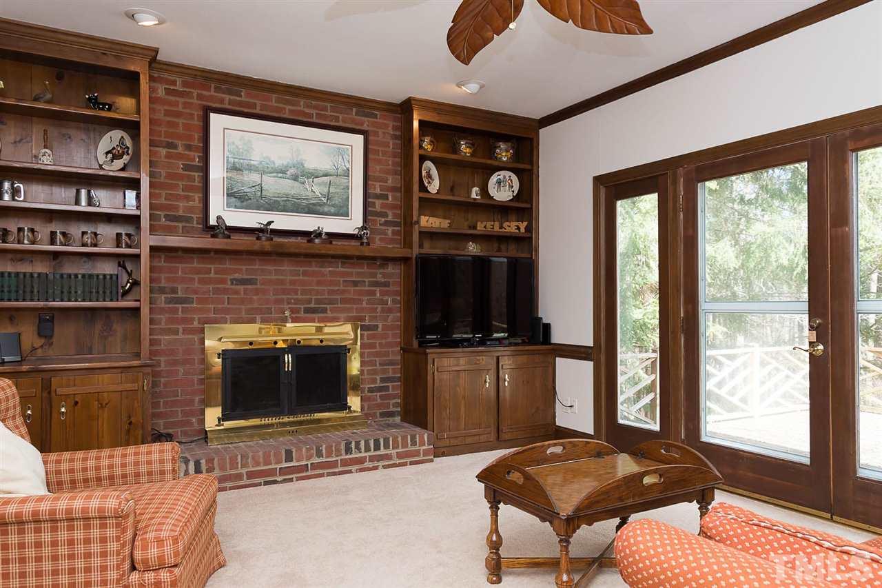 4820 Oak Way Raleigh, NC 27613 - Photo 7 of 25 a living room with furniture a flat screen tv and a fireplace