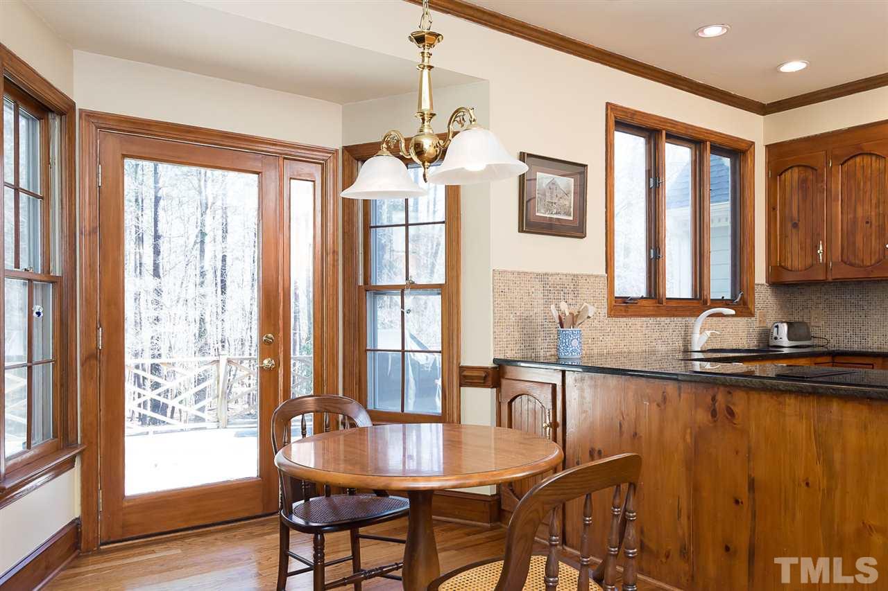 4820 Oak Way Raleigh, NC 27613 - Photo 9 of 25 a view of a a dining room with furniture window and wooden floor