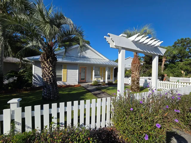 a view of a house with a small yard and plants