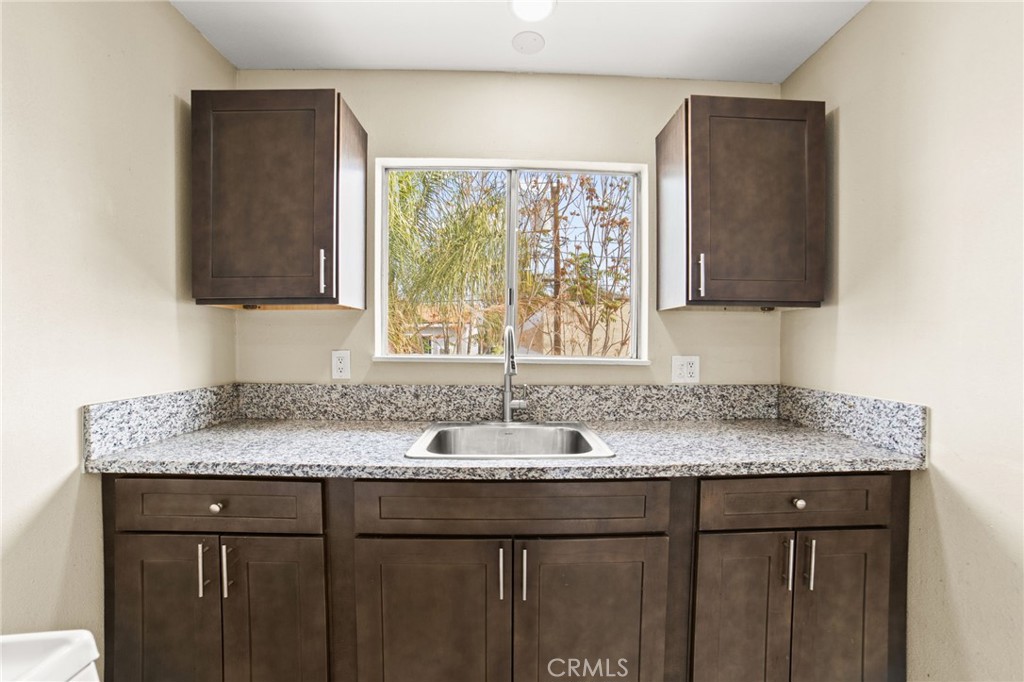 3717 Roosevelt Street Riverside, CA 92503 - Photo 20 of 27 a bathroom with a granite countertop sink and a mirror