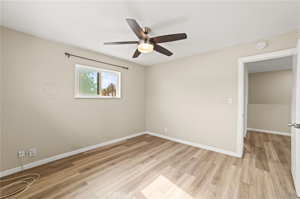 3717 Roosevelt Street Riverside, CA 92503 - Photo 25 of 27 an empty room with wooden floor and ceiling fan