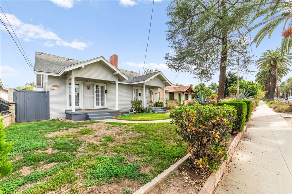 3717 Roosevelt Street Riverside, CA 92503 - Photo 3 of 27 a front view of a house with a garden and trees
