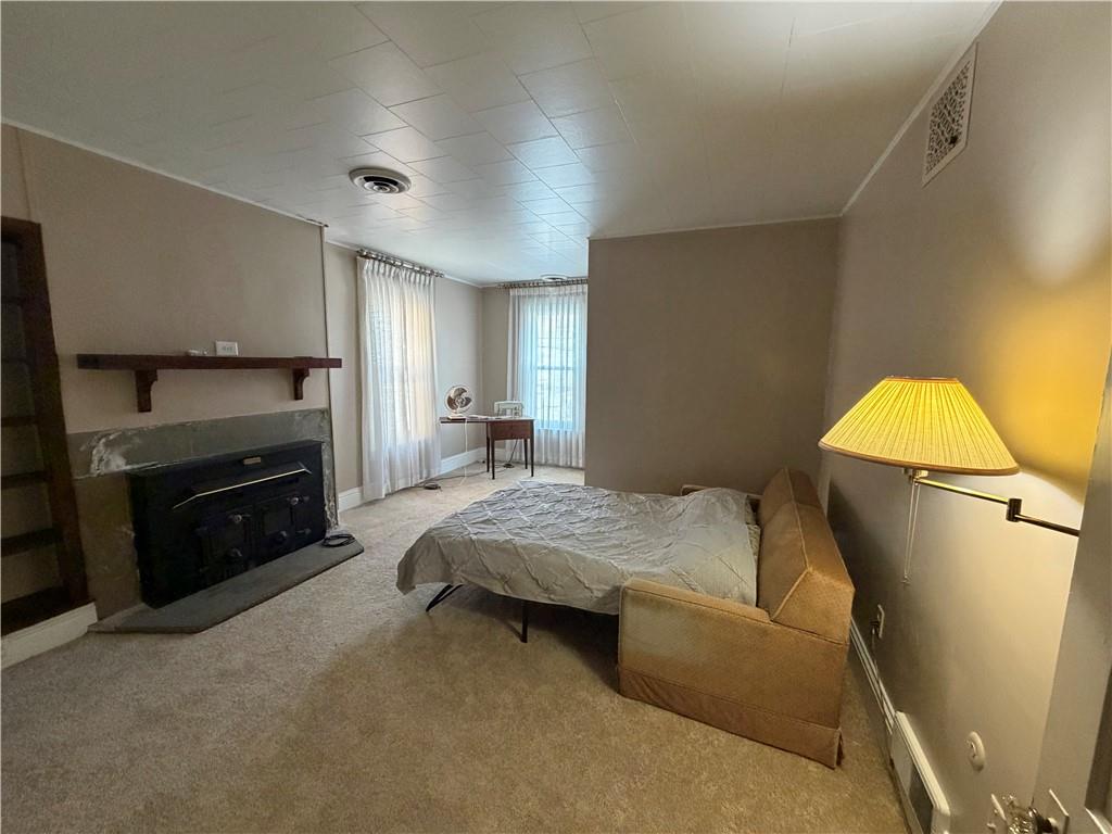149 Chess Street Monongahela, PA 15063 - Photo 18 of 35 a bedroom with a bed and a fireplace