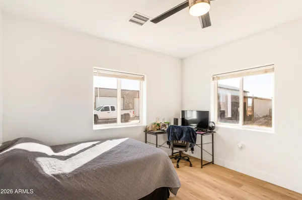 a bedroom with a bed and wooden floor