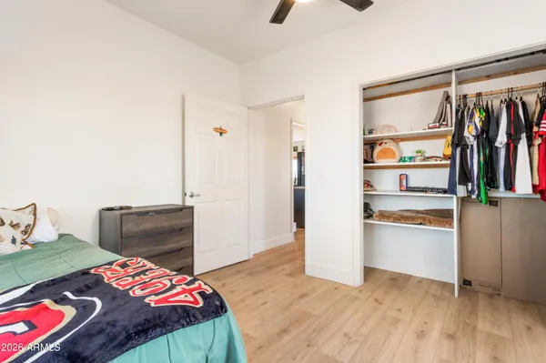 a bedroom with a bed and a dresser