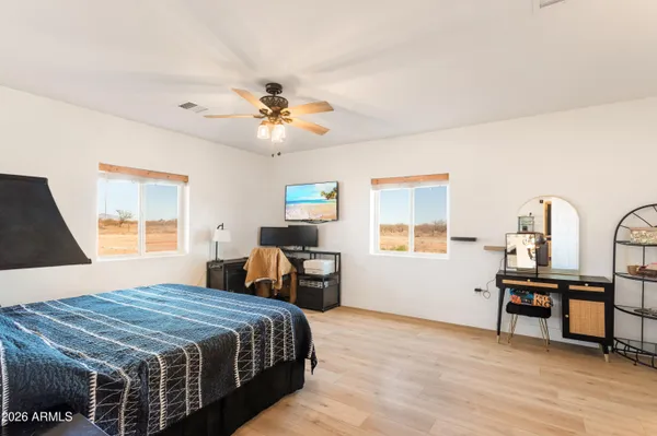 a bedroom with a bed dresser and a window
