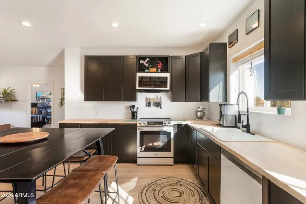 a kitchen with a sink stove and cabinets
